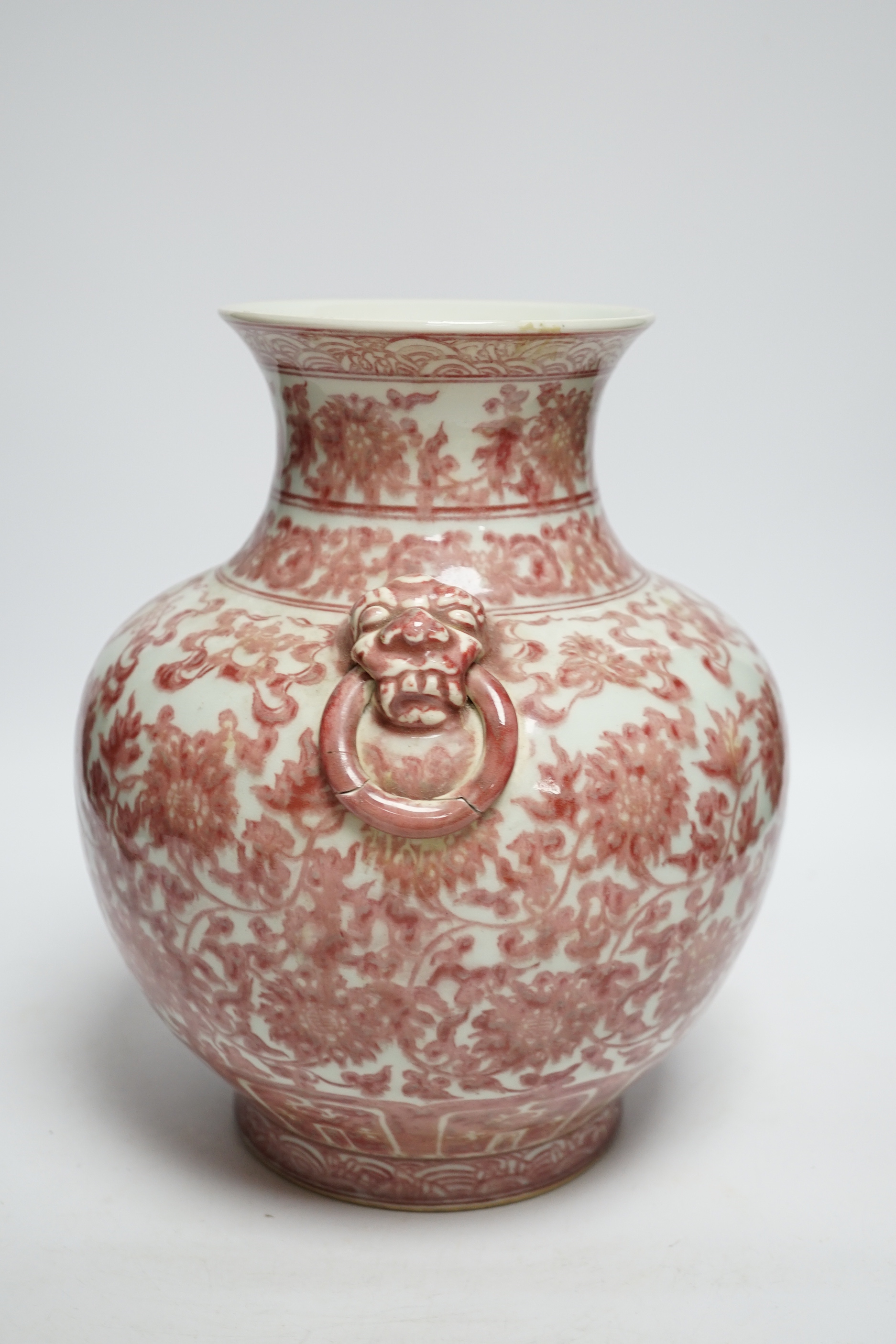 A Chinese underglaze copper red floral vase with twin handles, 27cm high